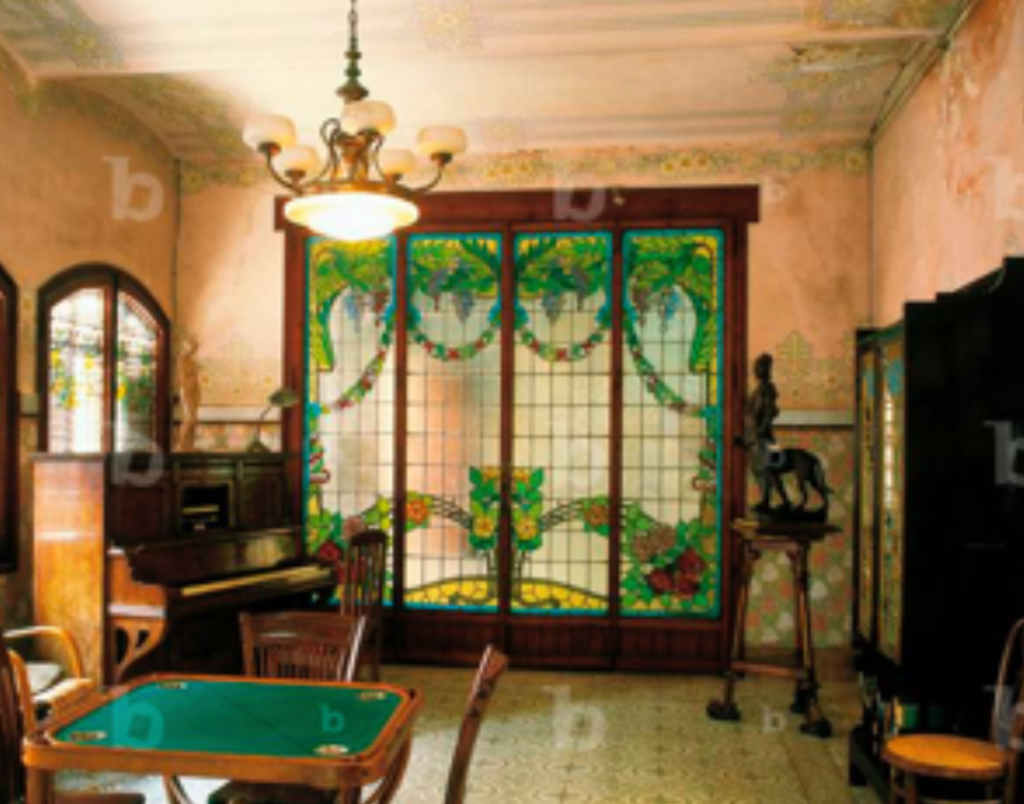 Stained glass separating the actual music room from the fireplace behind
