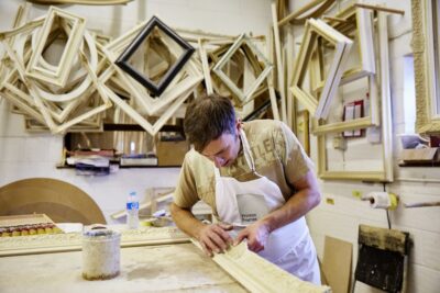 An Artwork Framer In His Workshop